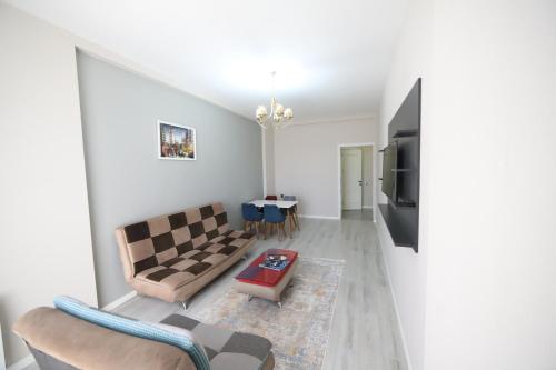 a living room with a couch and a tv at Passage Hotel in Baku