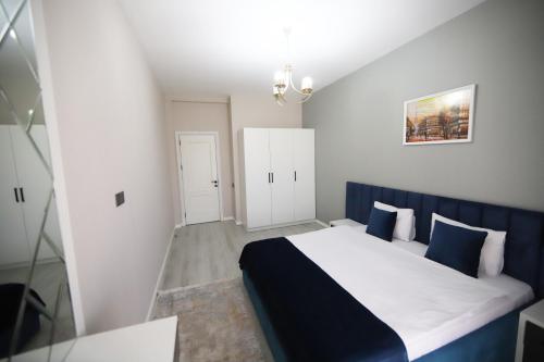 a small bedroom with a blue and white bed at Passage Hotel in Baku