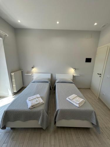 a bedroom with two beds with towels on them at B&b Al Centro Nicosia in Nicosia