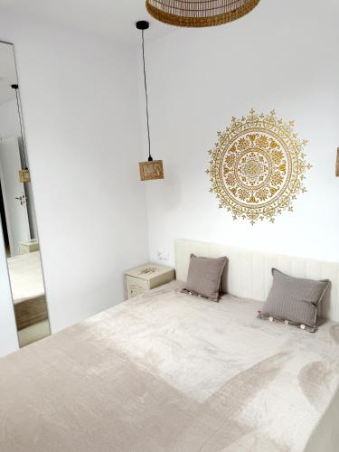 a bedroom with a large bed and a mirror at Apartament Szyszka in Rogowo