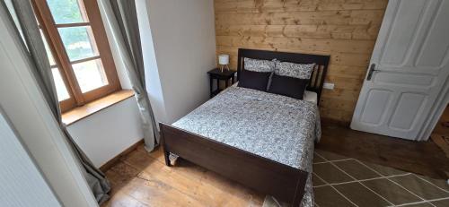 a bedroom with a bed in a room with a window at Pyrenean Pursuits in Biert