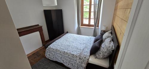 a small bedroom with a bed and a window at Pyrenean Pursuits in Biert