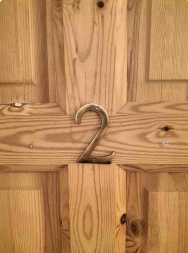 a wooden door with a metal handle on it at Lomonagh Lodge Portmagee in Lateeve