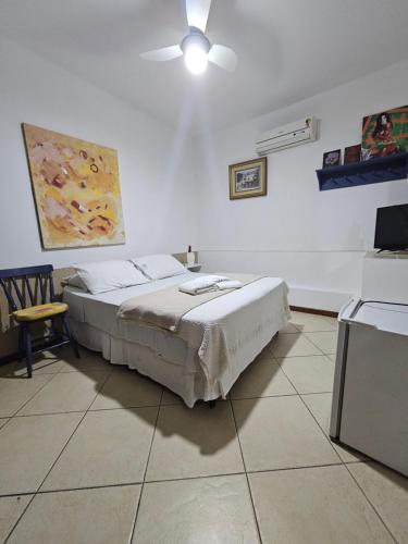 a bedroom with a bed and a ceiling fan at GH Bizkaia in Florianópolis