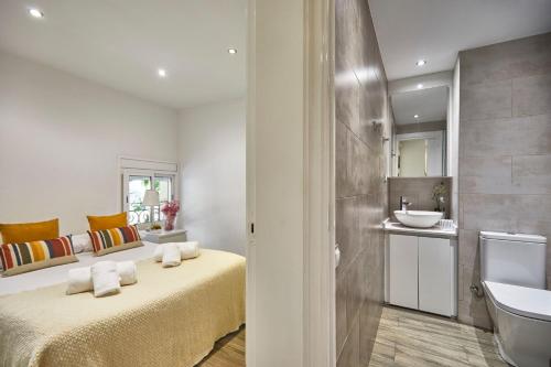 a bathroom with a bed and a sink at BBarcelona Sant Pau Flat in Barcelona