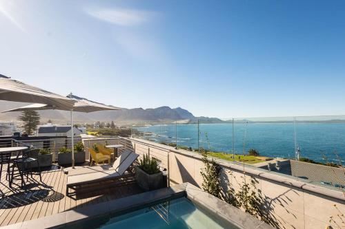 a swimming pool with a view of the ocean at Ocean-View Studio Apartment, Hermanus Waterfront - Apt 8 in Hermanus