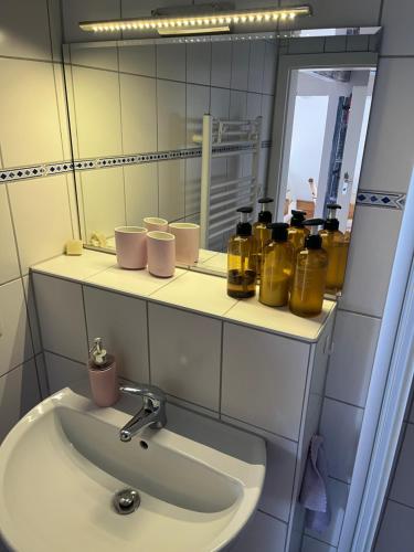a bathroom with a sink and a mirror at Hering FeWo II Apartment Balcony in Wiek auf Rügen 