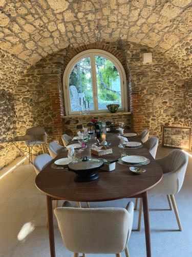 a dining room with a wooden table and chairs at Villa Scala Menaggio in Menaggio