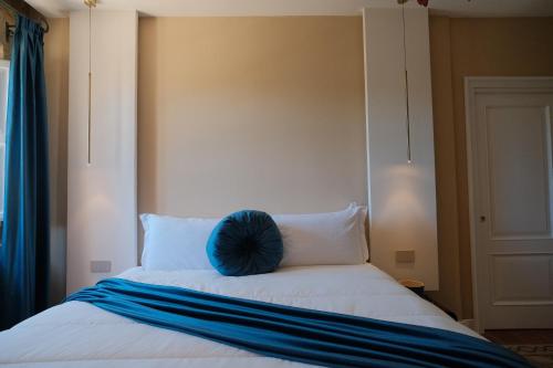 a bed with a blue pillow on top of it at Leano Agriresort in Piazza Armerina