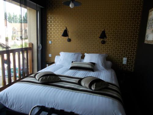 En eller flere senge i et værelse på Domaine de la Haie des Granges