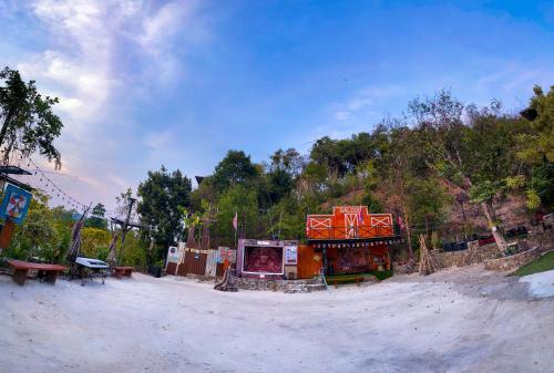 an amusement park with a building on a dirt road at Baan Bonkao Resort Sattahip in Ban Khlot