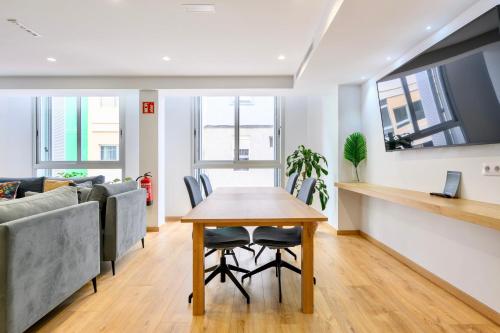 a living room with a table and a couch at Hotel Emeté & Coworking by Airnest in Las Palmas de Gran Canaria