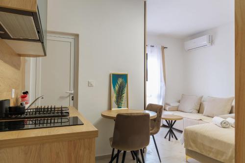 a small living room with a bed and a table at Apartments Donna in Bar