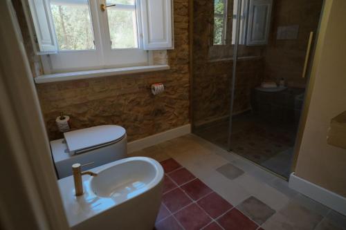 a bathroom with a toilet and a sink and a shower at Leano Agriresort in Piazza Armerina