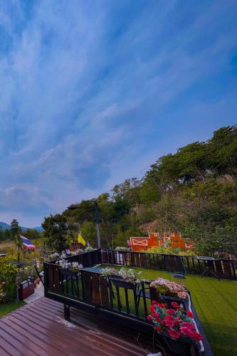 a balcony with a bunch of flowers on it at Baan Bonkao Resort Sattahip in Ban Khlot