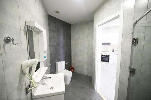 a bathroom with a white sink and a toilet at Passage Hotel in Baku