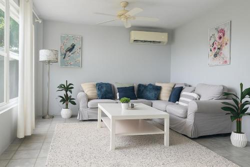 a living room with a couch and a table at BluEdge Villa VIP Resort Access in Tortola Island