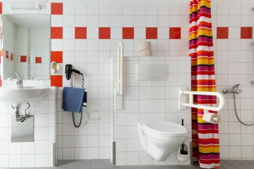 a bathroom with a toilet and a sink and a phone at Schanzenstern Altona GmbH in Hamburg