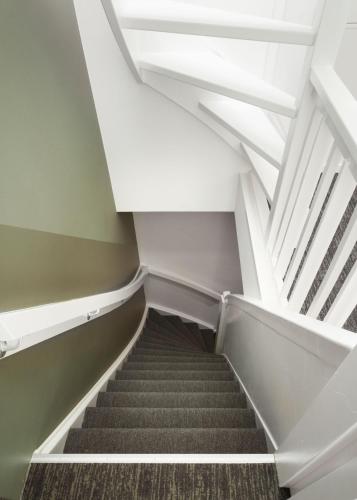 a staircase in an office building with a white ceiling at Limehome Utrecht Balijelaan in Utrecht