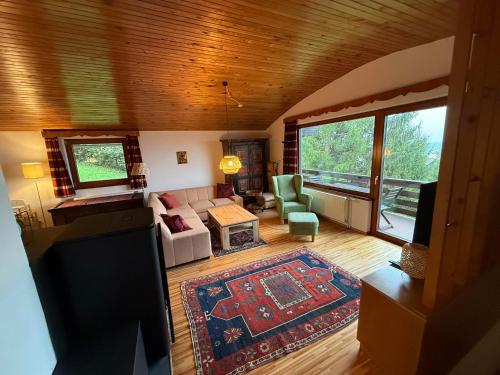 a living room with a couch and a rug at Ferienhaus Kötschach 356 in Kötschach