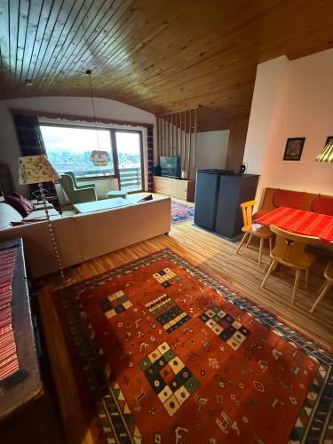 a living room with a couch and a table at Ferienhaus Kötschach 356 in Kötschach