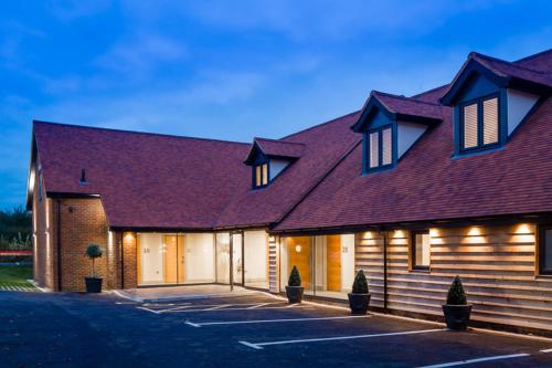 a large building with a red roof at The Chequers Inn in Beaconsfield