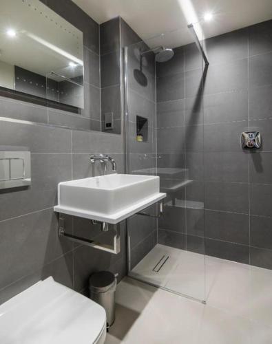 a bathroom with a sink and a toilet at The Chequers Inn in Beaconsfield