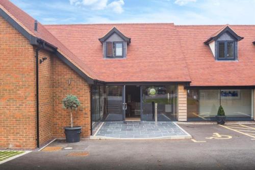 a brick building with a red roof at The Chequers Inn in Beaconsfield