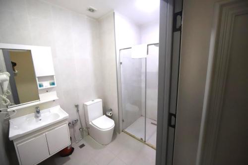 a bathroom with a shower and a toilet and a sink at Passage Hotel in Baku