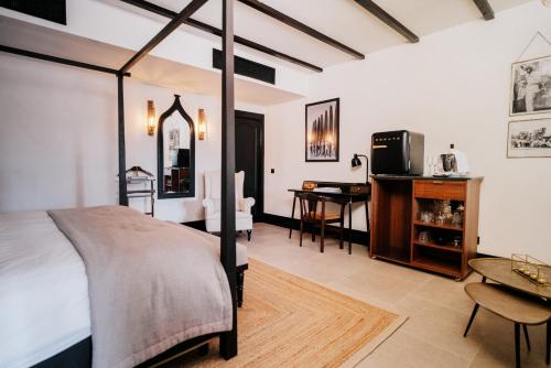 a bedroom with a bed and a desk in a room at Hotel Son Molí Country House in Playa de Palma