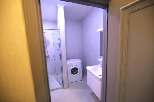 a bathroom with a washing machine and a washer at Passage Hotel in Baku