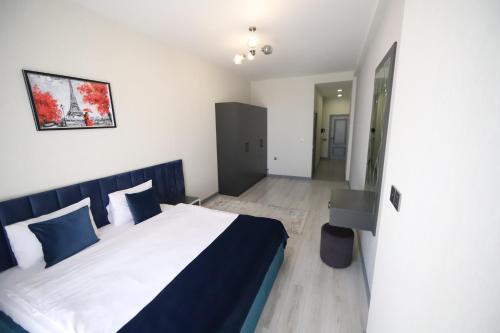 a bedroom with a bed with blue and white sheets at Passage Hotel in Baku