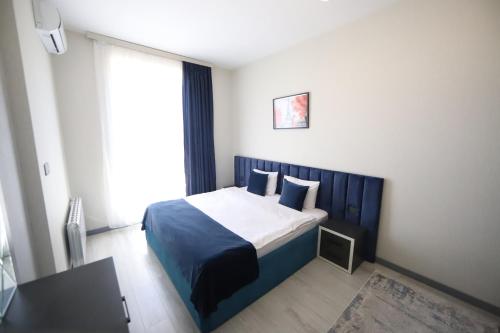 a bedroom with a bed in a room with a window at Passage Hotel in Baku