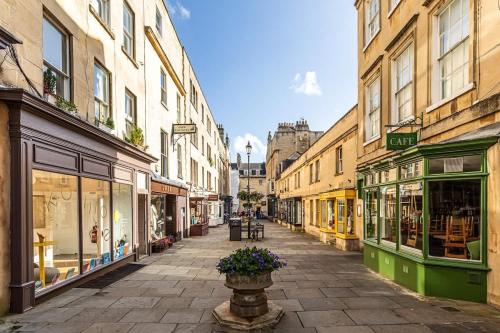 an empty city street with shops and buildings at Margarets Buildings Bath City Centre in Bath