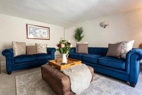 a living room with two blue couches and a table at Central, beautiful home - with parking in Bradford on Avon