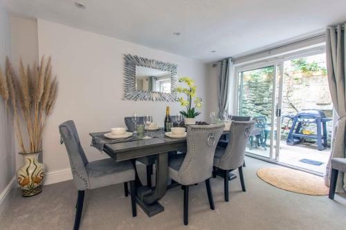 a dining room with a table and chairs and a mirror at Central, beautiful home - with parking in Bradford on Avon