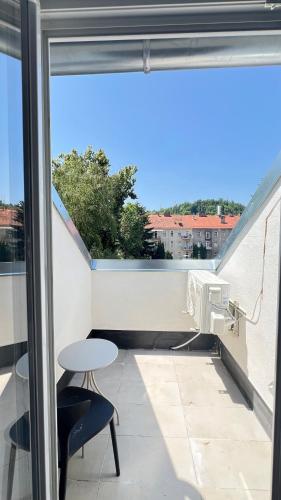 a balcony with a table and a desk and a window at Apartment Zhang in Graz