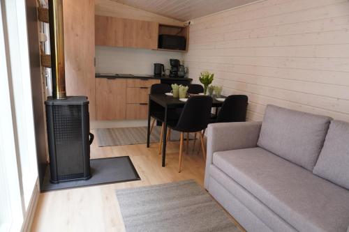 a living room with a couch and a table at Stuga med strandbastu in Oravais