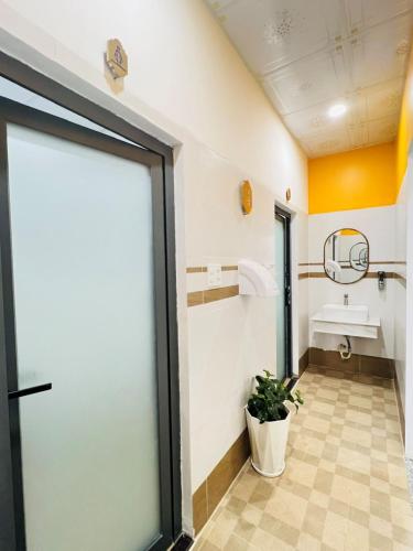 a bathroom with a sink and a mirror at ORCHID Hotel in Da Lat