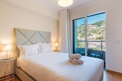 Ένα ή περισσότερα κρεβάτια σε δωμάτιο στο GuestReady - O Cantinho dos Pestanas