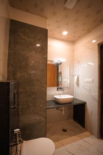 a bathroom with a sink and a toilet in it at Hotel Holy Pushkar by DIV Hospitality in Pushkar