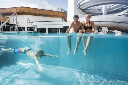 a group of people swimming in a swimming pool at Appartement Moni / Golf & Ski - TOP 9 in Bad Kleinkirchheim