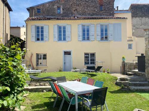 a table and chairs in front of a house at 3 pièces spacieux plein centre, parking,clim, terrasse, jardin in Foix