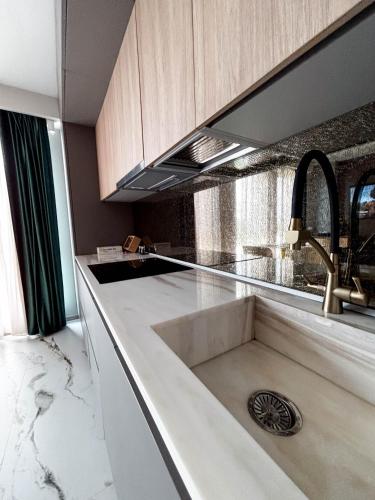 a kitchen with a sink and a counter top at Airport SkyLuxe Luxury Residence - Private Parking in Cluj-Napoca