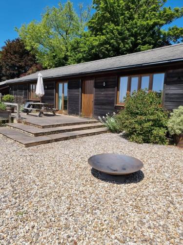 a house with a table in front of it at Beautiful Box Hill Lodge in Box
