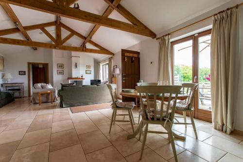 a living room with a table and chairs and a couch at Beautiful Box Hill Lodge in Box