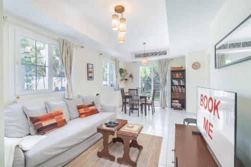 a living room with a couch and a table at Free housekeeping visits during your stay - StayShort - Vibrant Villa in Springs 11 Sleeps 6 with Balcony in Dubai