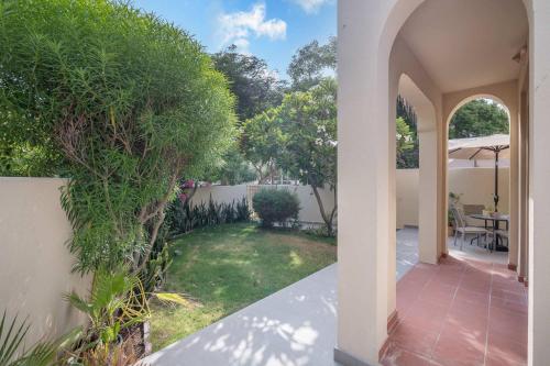 an archway leading to a yard with a garden at Free housekeeping visits during your stay - StayShort - Vibrant Villa in Springs 11 Sleeps 6 with Balcony in Dubai
