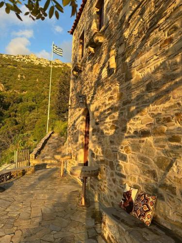 a stone building with a flag on the side of it at Paradisi Village in Neapolis