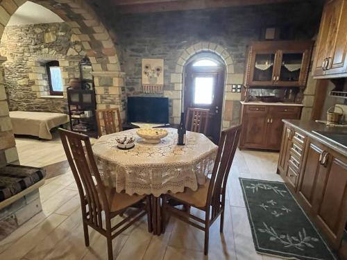 a dining room with a table and chairs and a kitchen at Paradisi Village in Neapolis